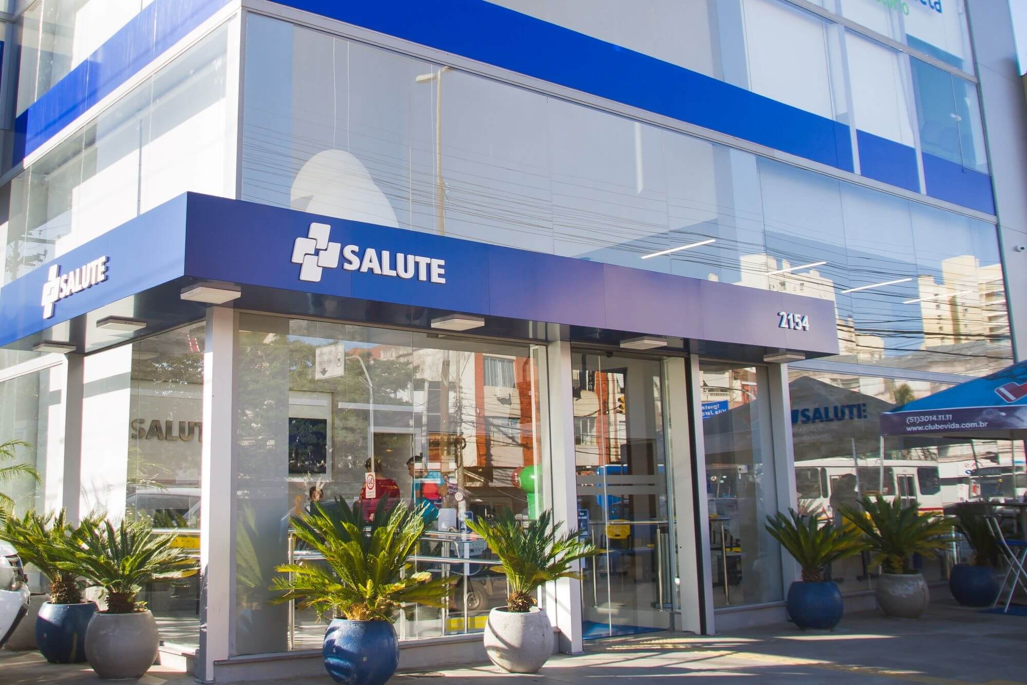 modern medical clinic building facade in Porto Alegre, Brazil, subjective camera angle, warm lighting, professional healthcare environment